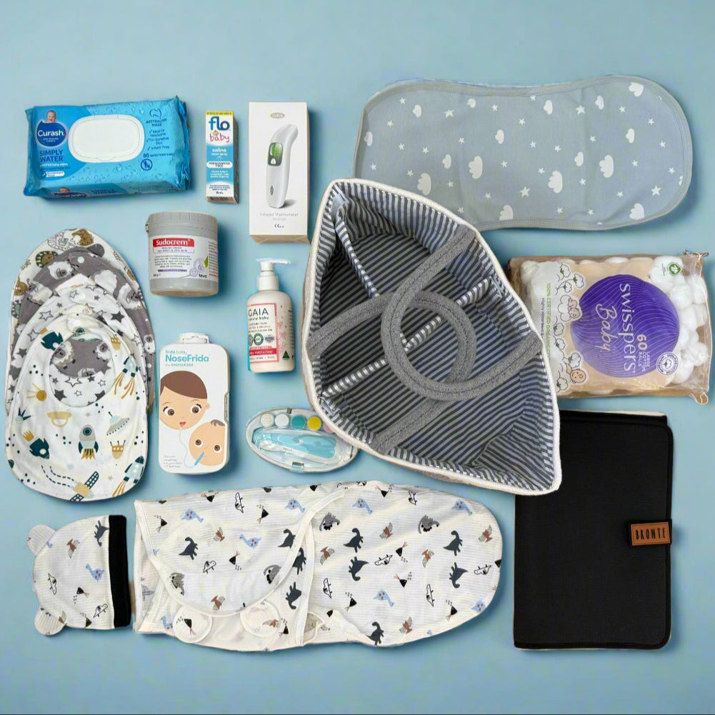 Collection of baby care products including diapers, wipes, and containers on a blue background